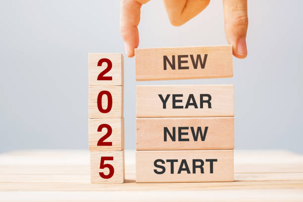 istock hand holding wooden block with text 2025 NEW YEAR NEW START on table background. Resolution, strategy, solution, business and holiday concepts 2158932628
