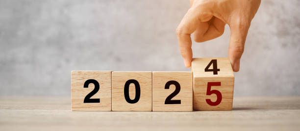 istock hand flipping block 2024 to 2025  text on table. Resolution, strategy, plan, goal, motivation, reboot, business and New Year holiday concepts 2158932644