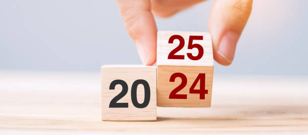 istock hand flip cube block 2024 to 2025 text on table. Resolution, review, strategy, end year, goal, business and New Year holiday concepts 2158932678