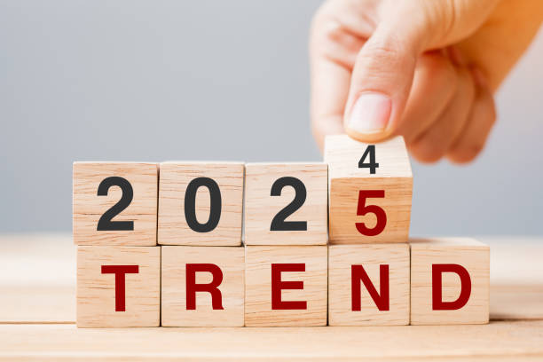 istock hand flipping block 2024 to 2025 TREND text on table. Resolution, idea, goal, motivation, reboot, business and New Year holiday concepts 2158932699