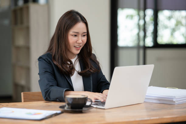 istock Asian business woman working on graph documents, office 2158934494
