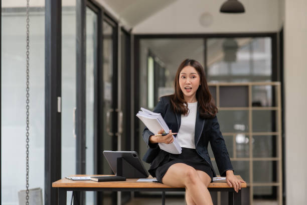 istock Asian business woman working on graph documents, office 2158934508