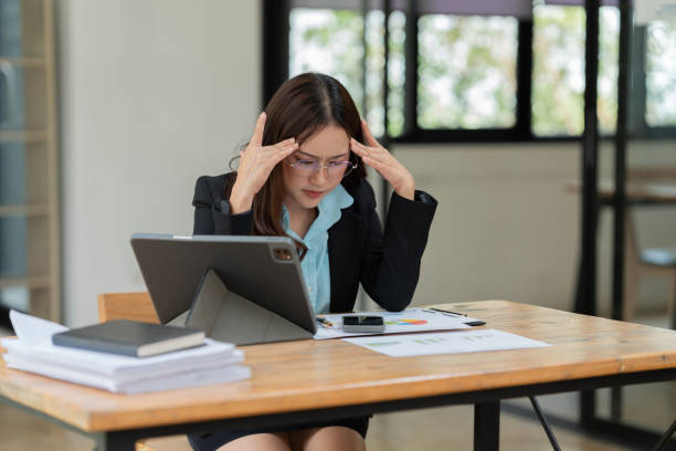 istock Asian business woman working on graph documents, office 2158934528