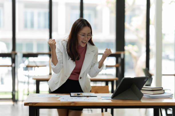 istock Asian business woman working on graph documents, office 2158934584