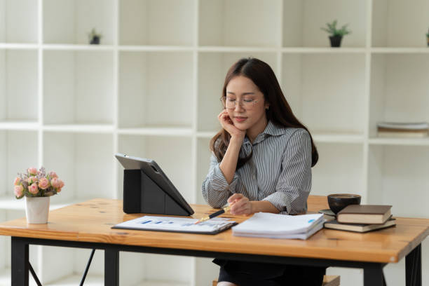 istock Asian business woman working on graph documents, office 2158934599