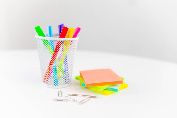 Office desk table with supplies, sticky notes and coloured pens. Top view with copy space. Flat lay. Time management.