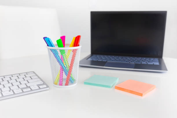 Office desk table with computer, supplies, sticky notes, notepad, coffee and pens. Top view with copy space. Flat lay.