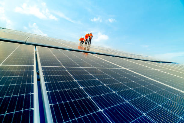 istock engineer man inspects construction of solar cell panel or photovoltaic cell by electronic device. Industrial Renewable energy of green power. factory worker working on tower roof. 2158938834