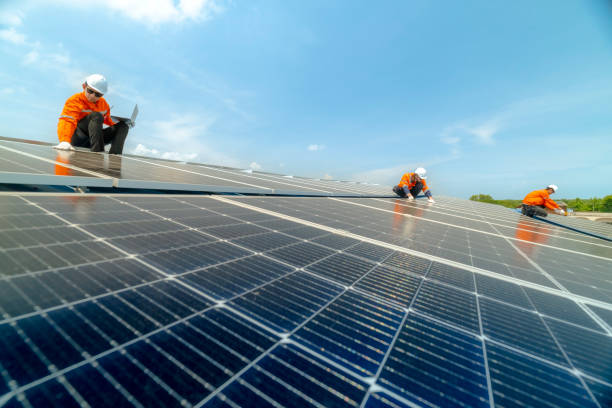 istock engineer man inspects construction of solar cell panel or photovoltaic cell by electronic device. Industrial Renewable energy of green power. factory worker working on tower roof. 2158939124