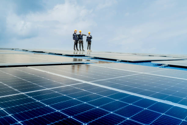 istock engineer man inspects construction of solar cell panel or photovoltaic cell by electronic device. Industrial Renewable energy of green power. factory worker working on tower roof. 2158939134