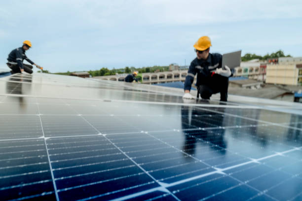 istock engineer man inspects construction of solar cell panel or photovoltaic cell by electronic device. Industrial Renewable energy of green power. factory worker working on tower roof. 2158939936