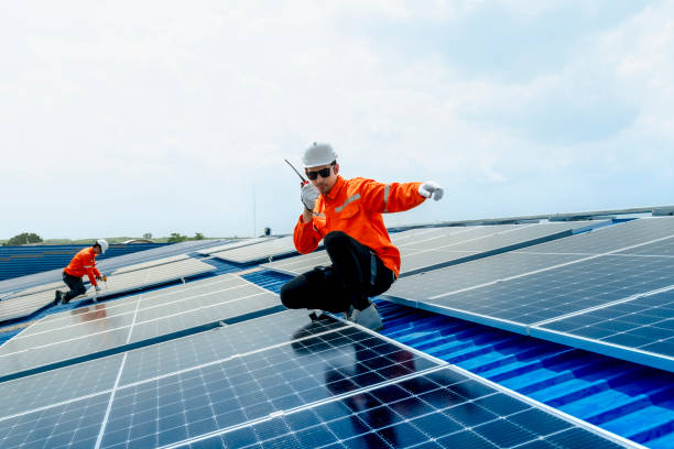 istock engineer man inspects construction of solar cell panel or photovoltaic cell by electronic device. Industrial Renewable energy of green power. factory worker working on tower roof. 2158939949