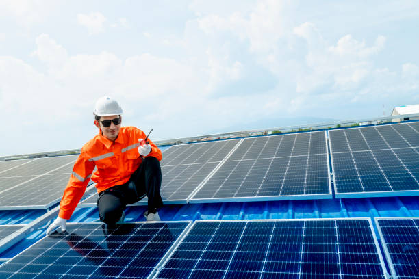 istock engineer man inspects construction of solar cell panel or photovoltaic cell by electronic device. Industrial Renewable energy of green power. factory worker working on tower roof. 2158940174