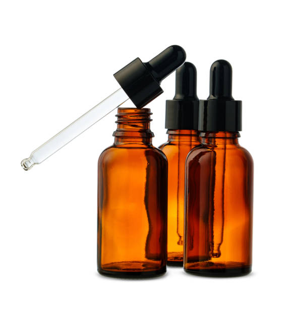 istock Three Amber Glass Dropper Bottles With Dropper Against White Background 2158940182