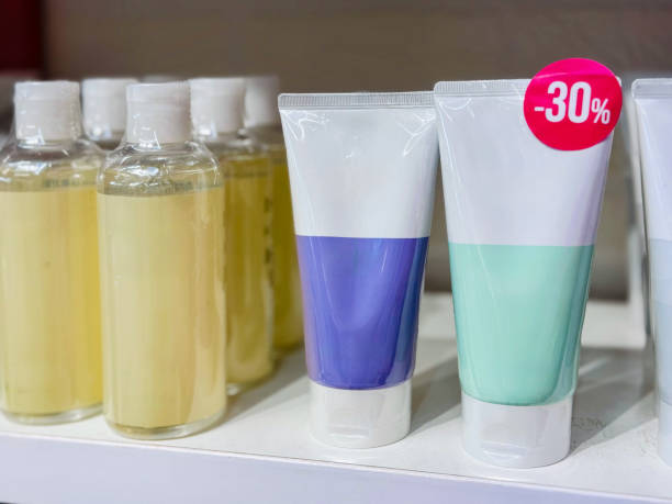 Various body care products with a discount label on a store shelf.