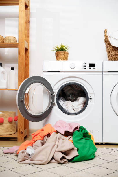 istock Laundry Day in a Modern Home With White Washers and a Wooden Shelf 2158942020