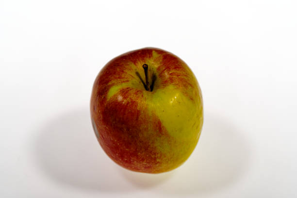 cooking and food concept - smiling female chef, holding a Red Delicious