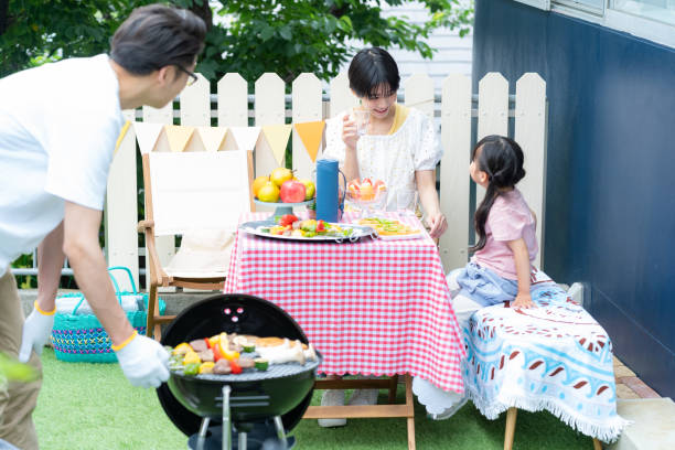 istock family enjoying barbecue 2158944002
