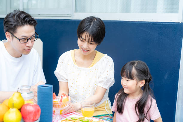 istock family enjoying barbecue 2158944038
