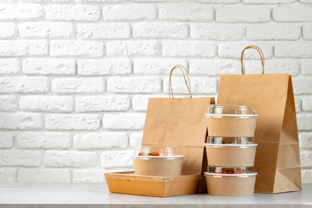 istock Take out food in boxes and craft bag against brick background 2158944541