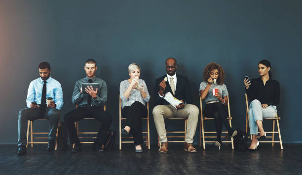 istock Business people, recruitment and waiting in line for hiring with interview process and employment opportunity. Diverse group, job seeker and impatient with eating or tech with mockup space and banner 2158944604