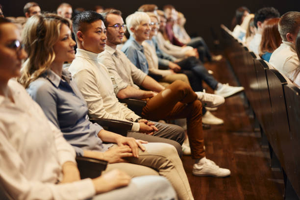 Crowd of people attending a seminar in convention center.