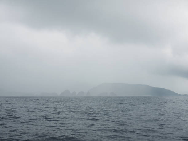Mysterious foggy coast with dangerous distant rocks, Okinawa