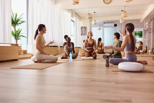 istock Happy female athletes talking on a break in Yoga studio. 2158946286