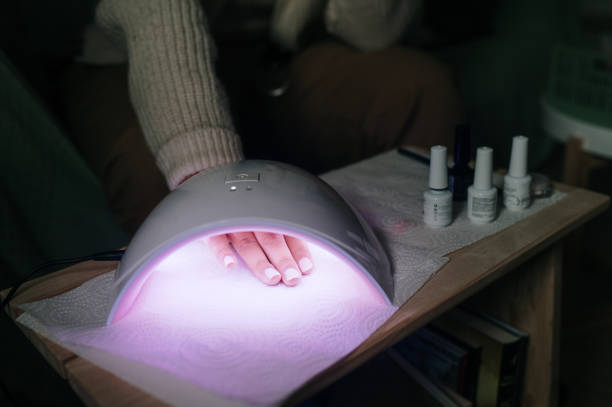 istock Woman doing her nails at home 2158947064