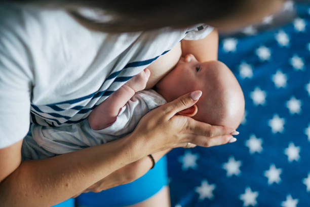 young mother is  breastfeeding her newborn baby