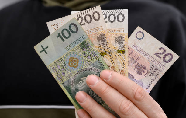 istock A man holds banknotes in his hand, savings, minimum wage 2158948905