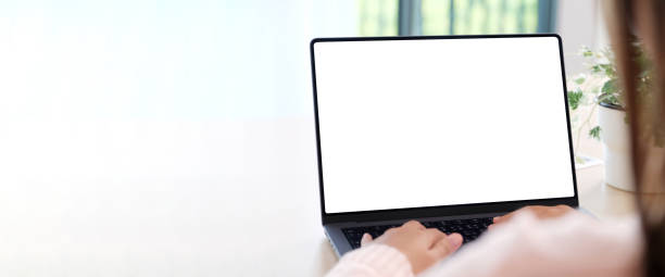istock Woman using laptop computer with blank screen for mock up template background with copy space, people business technology and lifestyle background concept 2158949868