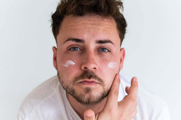 istock Man using cosmetics taking care of the skin 2158950662
