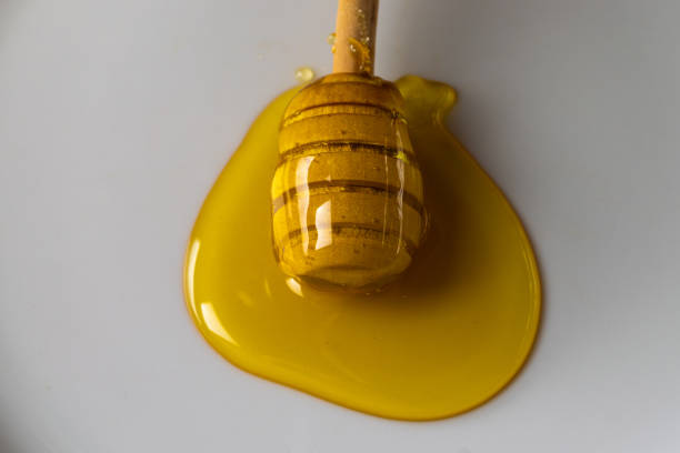 Honey and wooden dipper