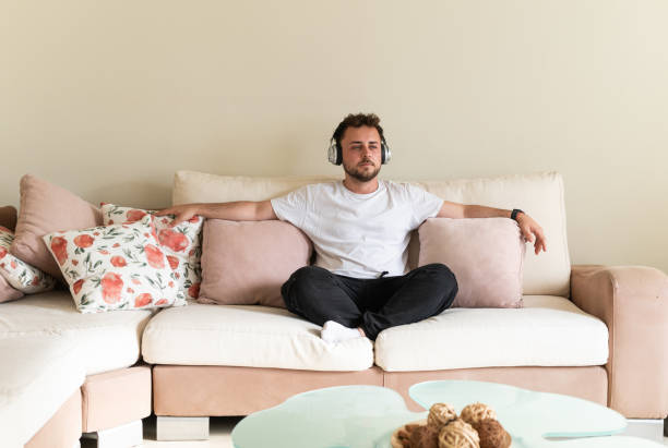 istock Man relaxed on the sofa listening to music 2158951088