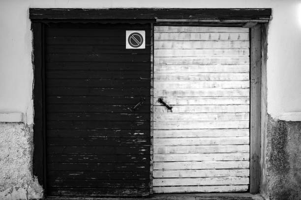 Black and white door representing some symbolism with different sides.