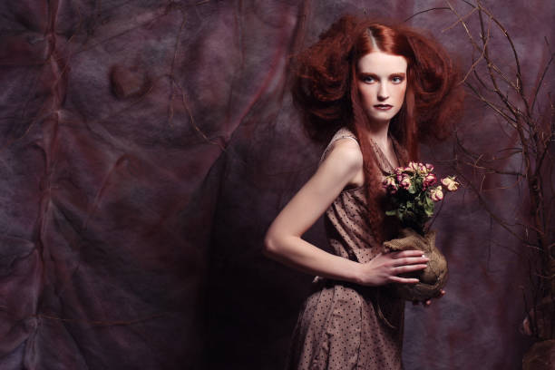 istock beautiful girl with dry roses 2158951745