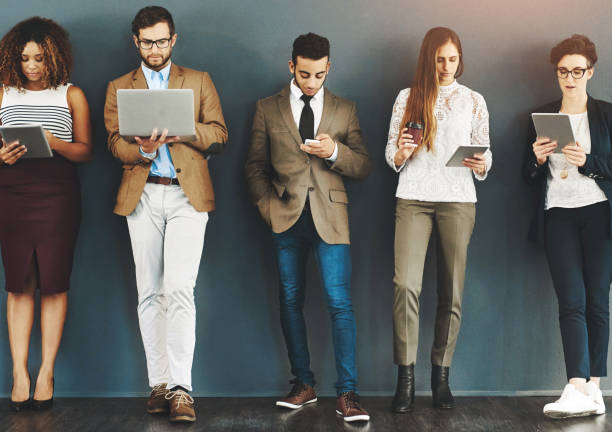 istock Group, people and standing row with technology for hiring, international diversity for corporate company. Crowd, men and women with mobile application for onboarding, waiting for interview with hr 2158951786