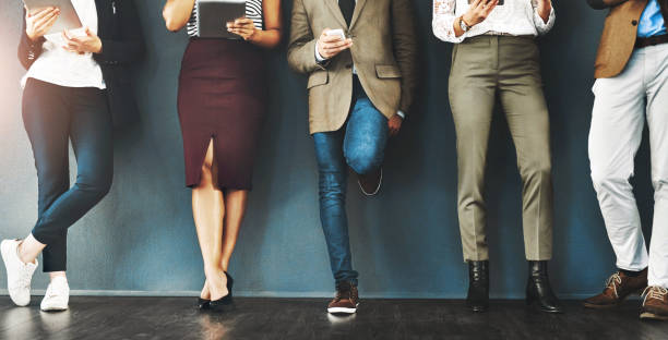 istock Connected, communication and network of diverse businesspeople using multimedia technology, waiting for an interview. Professional group standing in a row, browsing social media with online apps 2158951797