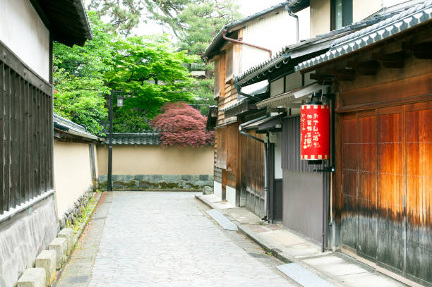 Kurashiki Bikan Historical Quarter in dusk. Townscape known for characteristically Japanese white walls of residences and willow trees lining banks of Kurashiki River. Okayama Prefecture, Japan