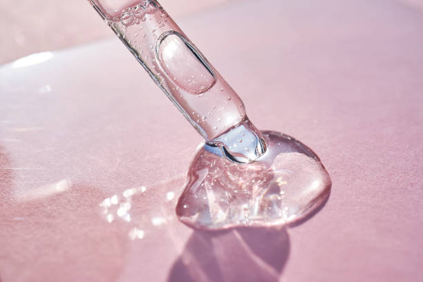 istock Pipette with serum shimmering in the sun on a pink background. 2158954871