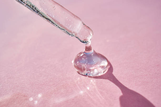 istock Pipette with serum shimmering in the sun on a pink background. 2158954969