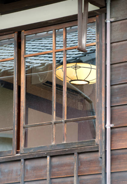 Wooden window frame, Nagamachi District, Kanazawa, Honshu, Japan. Nagamachi, the Samurai District, is known for its homes and gardens from Japan’s feudal era with residences of the leading warrior clan, Kanazawa, Honshu, Japan. Honshu, Japan’s main island with most of the country’s major cities and cultural sites. From the busy global hub of Tokyo for finance, industry, fashion and cuisine to Mount Fuji, the iconic, snow-capped volcano and the city of Kyoto, famed for Zen temples, gardens and traditional geisha entertainment