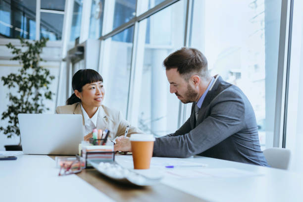 istock Two employees engaging in a lively discussion 2158956308