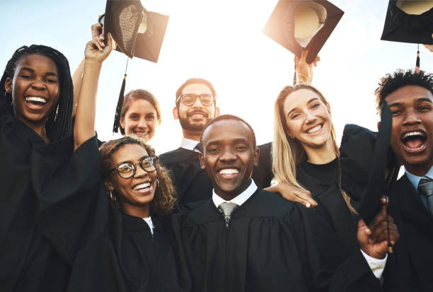 istock Group, people and diversity at university graduation, happiness for degree or diploma certificate. Team, students and celebrating for in portrait achievement at college campus, smile for knowledge 2158956547