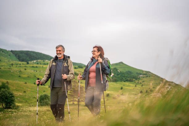 istock Active Senior Couple on Nature Hike with Trekking Poles 2158956639
