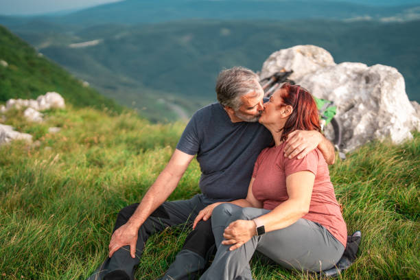 istock Affectionate Senior Couple Pausing for a Kiss on Hike 2158956707