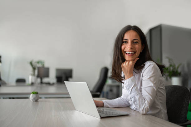 istock Attractive businesswoman smiling and working 2158956763