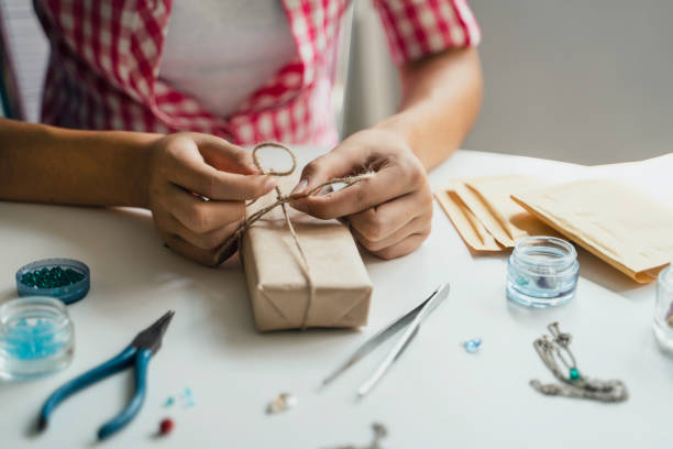 istock Tying a bow on a handmade jewelry package with precision 2158957576