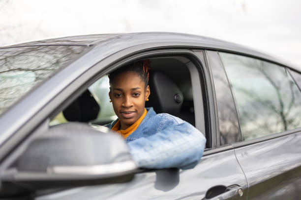 istock Beautiful black woman driving car 2158958232